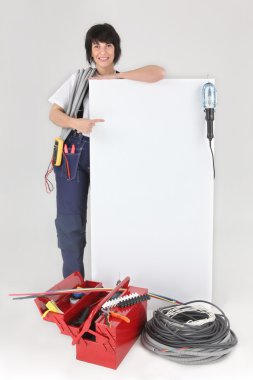 Tradeswoman pointing to a blank sign clipart