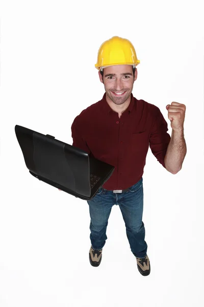 Tight-fisted craftsman with laptop — Stock Photo, Image