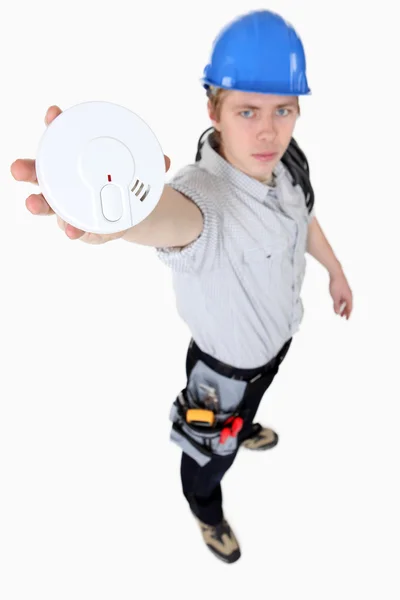 Builder holding smoke alarm — Stock Photo, Image