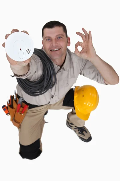 Electrician with a smoke alarm — Stock Photo, Image