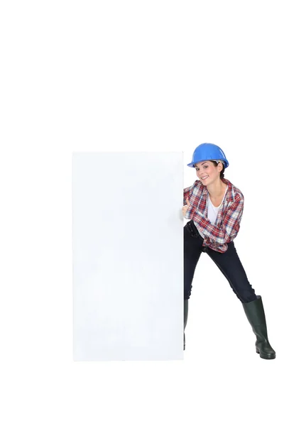 Woman laborer showing white board for message — Stock Photo, Image