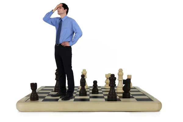 Man standing on a chess board — Stock Photo, Image