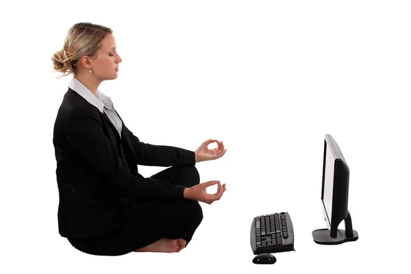 Young pretty businesswoman doing yoga — Stock Photo, Image