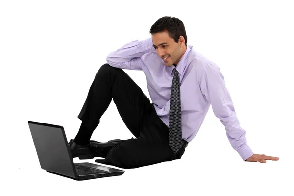 Businessman watching a movie on his laptop — Stock Photo, Image