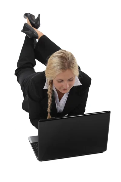 Woman lying at a laptop — Stock Photo, Image