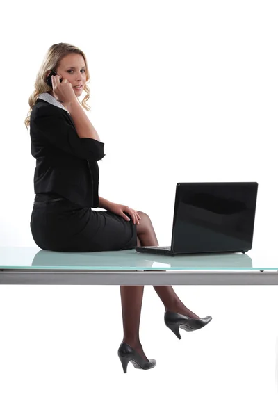 Woman sitting on her desk — Stock Photo, Image