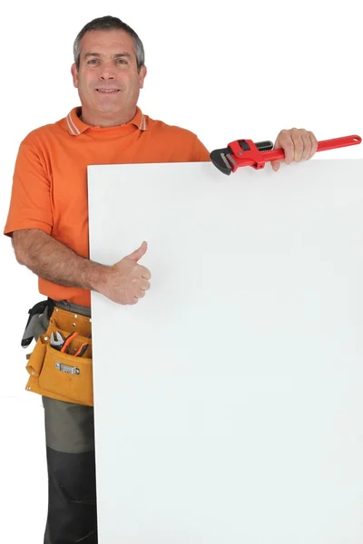 Plumber holding message board — Stock Photo, Image