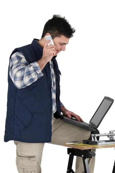 Busy tradesman posing with his building materials — Stock Photo, Image