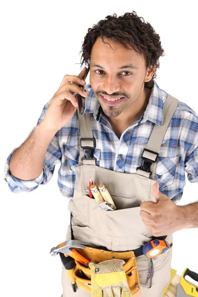 Carpinteiro recebendo boas notícias pelo telefone — Fotografia de Stock