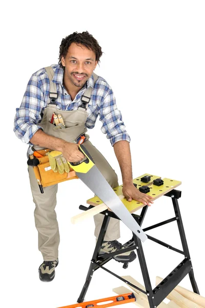 Man sawing a plank of wood — Stock Photo, Image