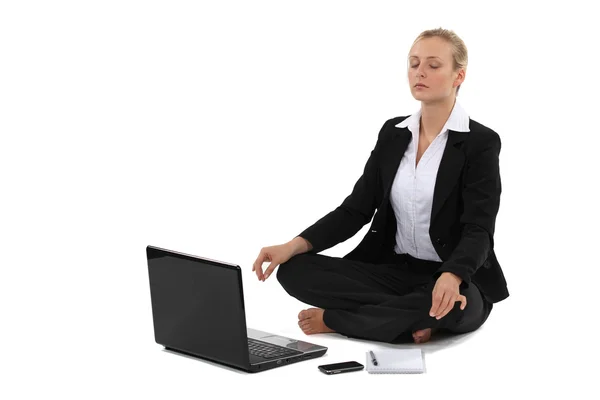 Businesswoman sat in yoga position Royalty Free Stock Images