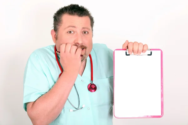 Male nurse looking scared holding notepad — Stock Photo, Image