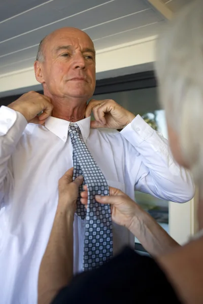 Woman straightening a tie — Stock Photo, Image