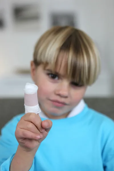 Little boy with bandage on finger — Stock Photo, Image