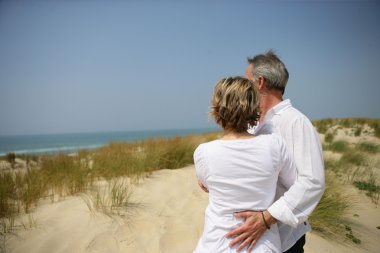 Couple embracing in dune clipart
