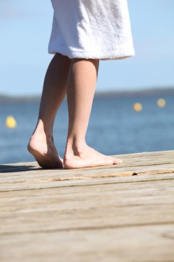 Barefoot on a jetty clipart