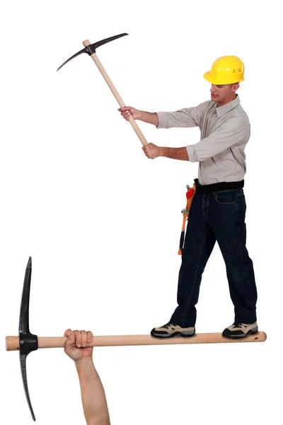 Worker wielding a pick-ax — Stock Photo, Image