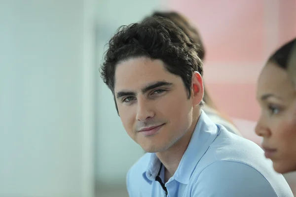 Young man in an office meeting — Stock Photo, Image