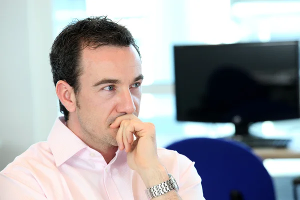 Pensive man in office — Stock Photo, Image