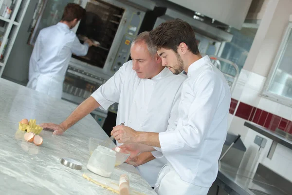 training cook apprentice trainee cooking with chef