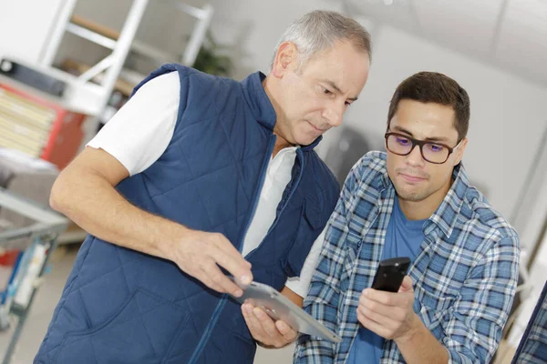 Män Som Håller Tabletter Och Fjärrkontroll — Stockfoto