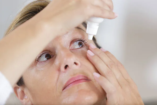 Una Mujer Gotas Para Los Ojos —  Fotos de Stock