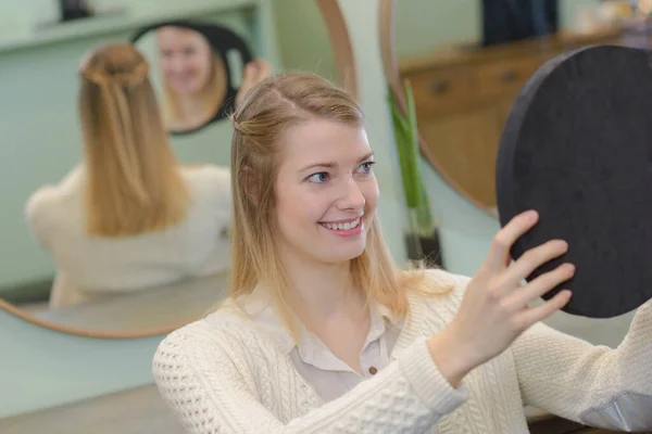 在镜子里欣赏发型的女人 — 图库照片