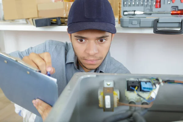 Homem Escrevendo Notas Sobre Uma Máquina — Fotografia de Stock