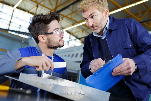 Apprendista Ingegnere Discussione Oggetto Metallico Con Supervisore — Foto Stock