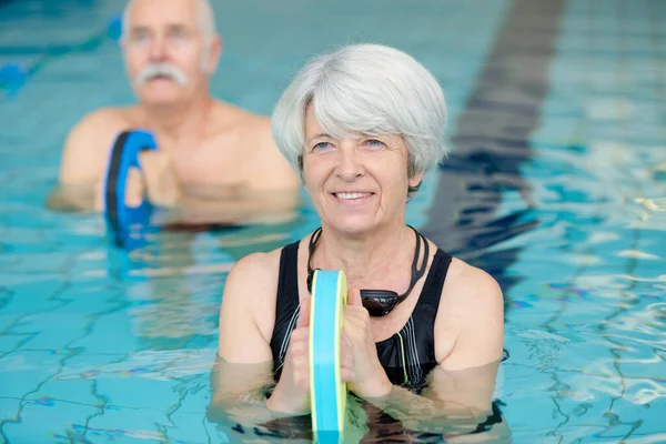 Senior Woman Doing Water Exercise Kicking Board — Stock Photo, Image
