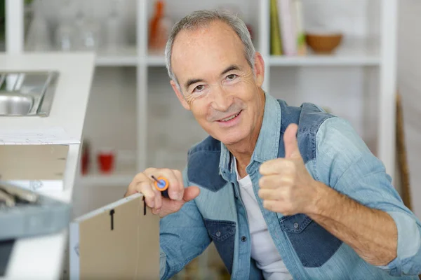 Senior Man Assembling Furniture Screwdriver Holding Thumbs — Stock Photo, Image