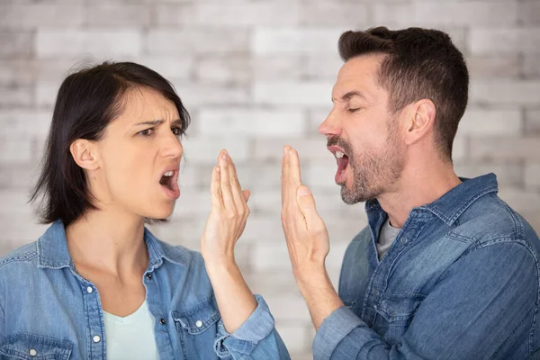 angry young couple shouting face to face