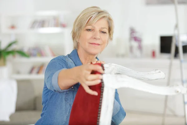 Senior Woman Fixing Chair Staple — Stock Photo, Image