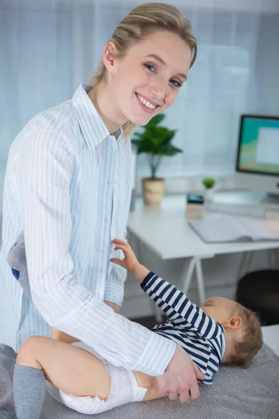 Cheerful Female Pediatrician Holds Newborn Baby — Stock Photo, Image