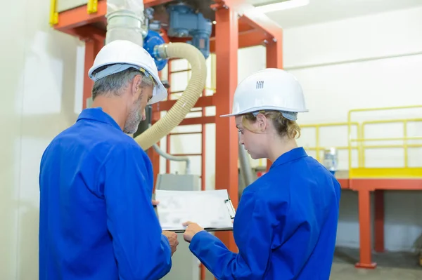 stock image factory engineer studying the plan