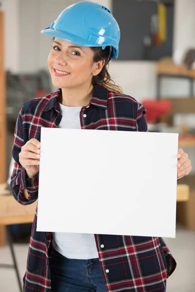 Woman Builder Holding White Banner — Stock Photo, Image
