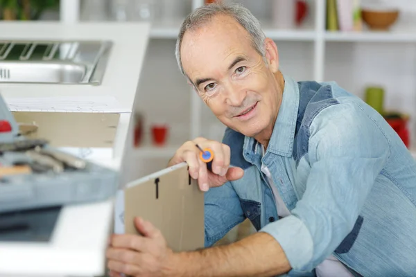 Happy Senior Man Screwing Screws Furniture Fittings — Stock Photo, Image