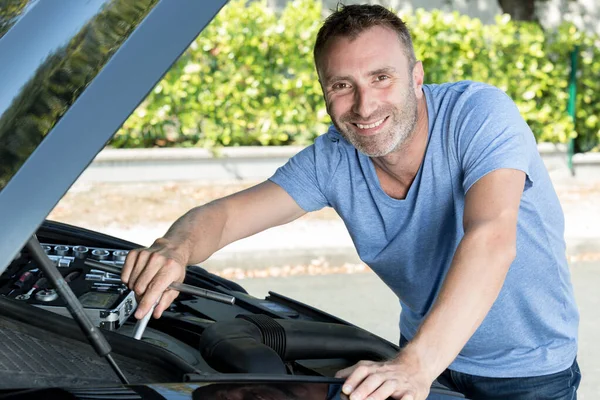 Smiling Happy Man Fixing Outdoors — Stockfoto