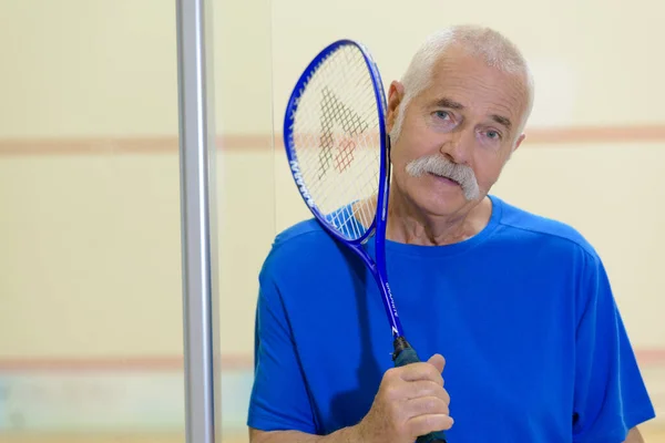 Senior Man Playing Tennis Indoors — Stockfoto