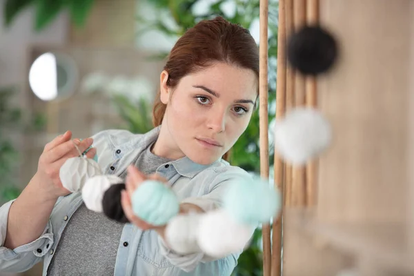 Woman Putting Garland Decorative Paper Lights — Stockfoto