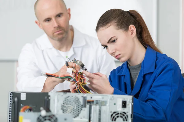 Attentive Female Technician Fixing Cables — 스톡 사진