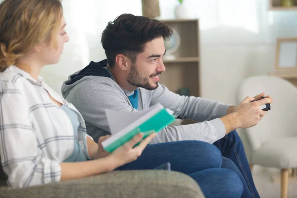 Picture Woman Reading Book Man Playing Videogame — Stock Photo, Image