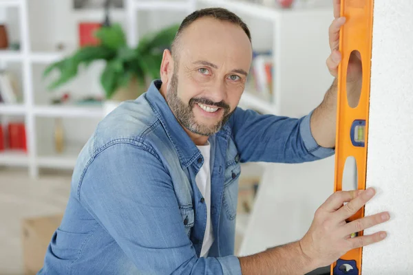 Portrait Man Using Spirit Level Home — Stock Fotó