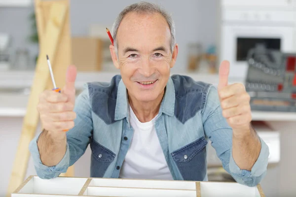 Senior Handyman Giving Thumbs Home — Zdjęcie stockowe