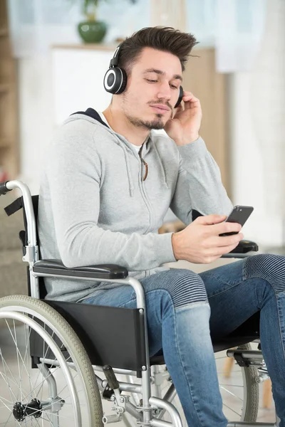 Man Sitting Wheelchair Listening Music Headphones — Stock Fotó