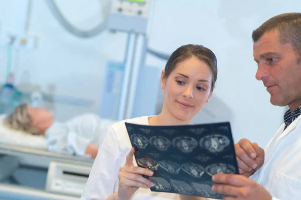 Medical Staff Looking Scan Results Patient Background — Fotografia de Stock