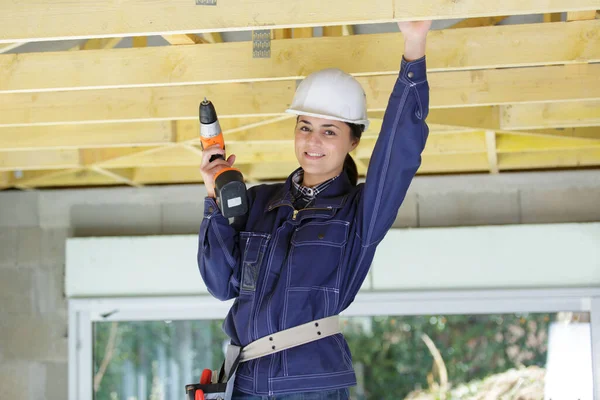 Female Builder Drilling Wooden Frame —  Fotos de Stock