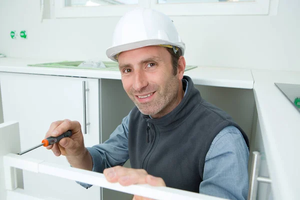 Happy Serviceman Fixing Cabinet Screwdriver Kitchen — Stock Photo, Image