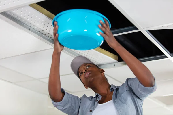 Woman Holding Bowl Leaking Ceiling Panel — Stock Photo, Image