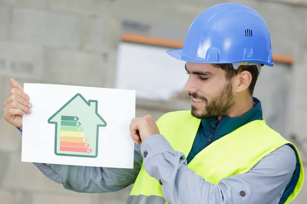 Man Builder Showing Energy Charts — Stock Photo, Image